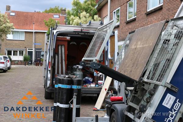 Dakdekkersbusje met materiaal en ladderlift voor dakpannen vervangen in Winkel Dakdekkersbusje met materiaal en ladderlift voor dakpannen vervangen in Winkel