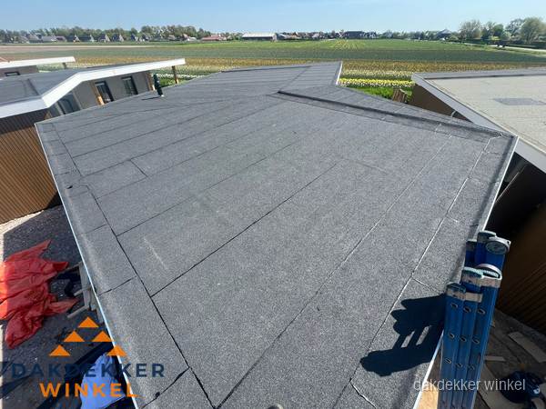Nieuw bitumen plat dak met uitzicht over landschap in Winkel