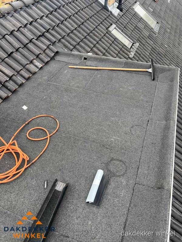 Plat dak reparatie met gereedschap en loodstroken in Winkel